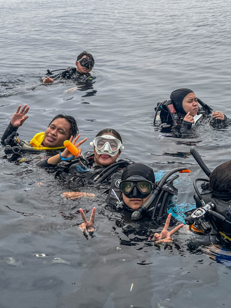 Mahasiswa peserta pelatihan selam HIMITEKA-IPB berpose ceria di permukaan laut.